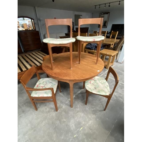 104 - Mid century 'Nathan' teak extending dining table 76H 122cm diameter and 6 chairs including 2 carvers