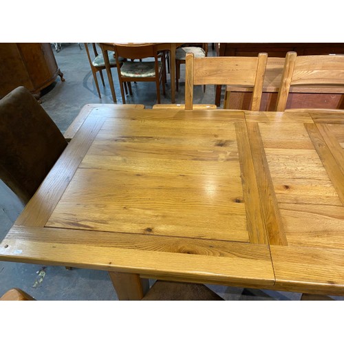 92 - Barker & Stonehouse extending oak dining table 79H 250W 100D with 6 matching chairs and 2 brown sued... 