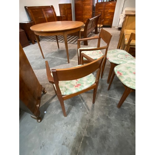 104 - Mid century 'Nathan' teak extending dining table 76H 122cm diameter and 6 chairs including 2 carvers