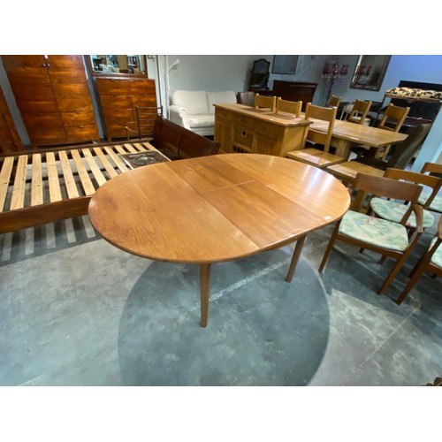 104 - Mid century 'Nathan' teak extending dining table 76H 122cm diameter and 6 chairs including 2 carvers