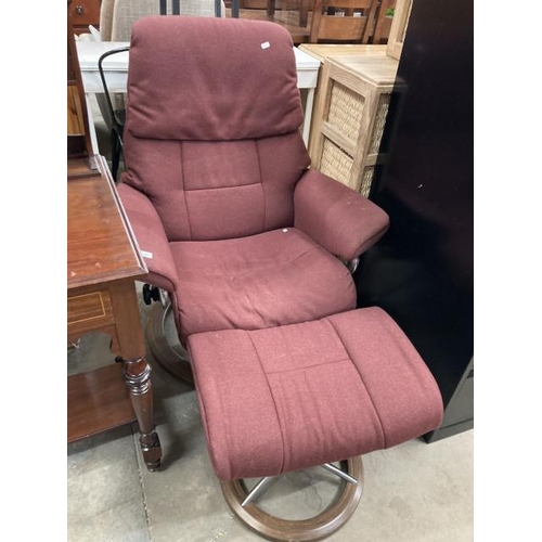 595 - Ekornes burgundy upholstered swivel, reclining chair 82W and a matching footstool