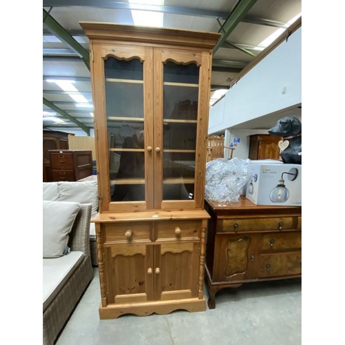 67 - Pine glazed bookcase on cupboard 214H 87W 45D