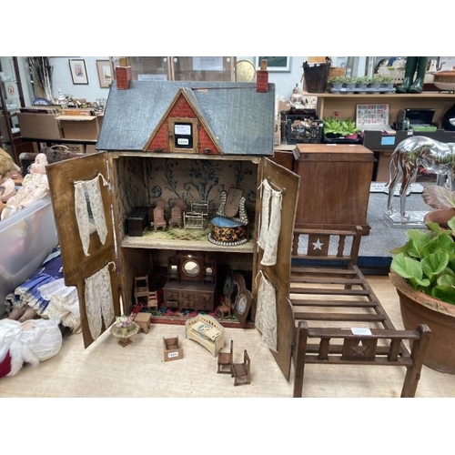 556 - Vintage dolls house with furniture and accessories and a wooden dolls bed (no mattress/bedding)