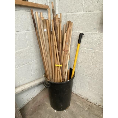 9 - Tub of broom handles, bamboo etc