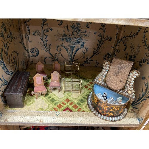 556 - Vintage dolls house with furniture and accessories and a wooden dolls bed (no mattress/bedding)