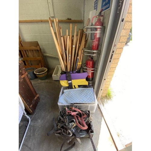 12 - Tub of broom handles, bamboo, assorted horse tack etc