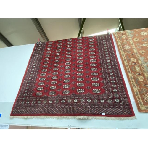 259 - Red ground Persian Bokhara rug 280 x 190cm