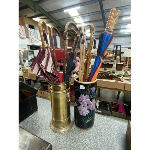 283 - Ceramic decorated stick stand 45H and a brass stick stand 45H both with umbrellas etc