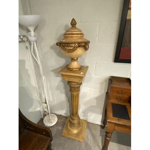 34 - Carved wooden plinth 115H 33W 33D with a resin urn 56H