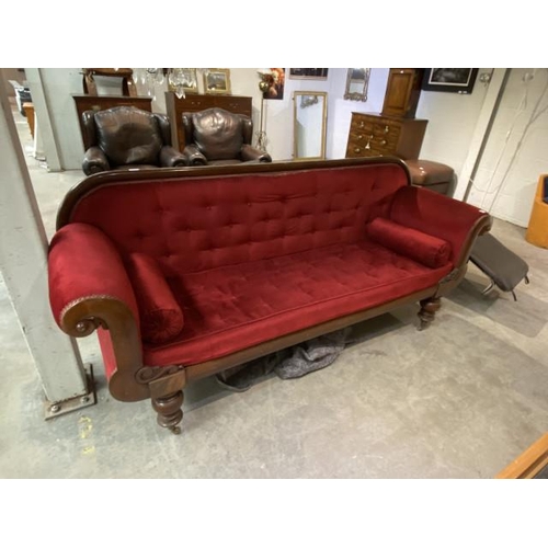 64 - Victorian mahogany framed settee with scroll arms and 2 bolster cushions 220W