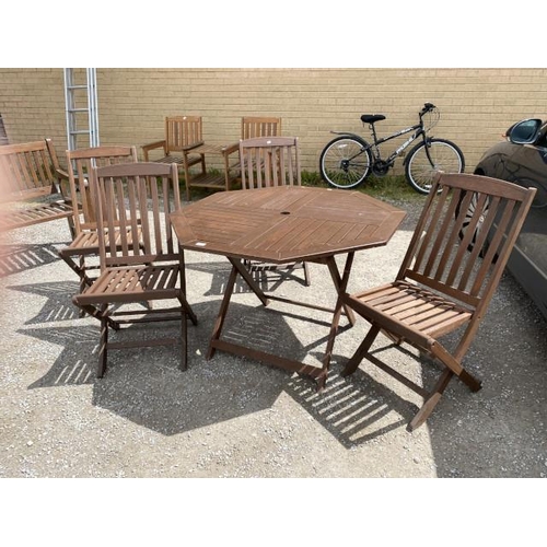 226 - Octagonal teak folding garden table 74H 106W 106D and 4 folding chairs