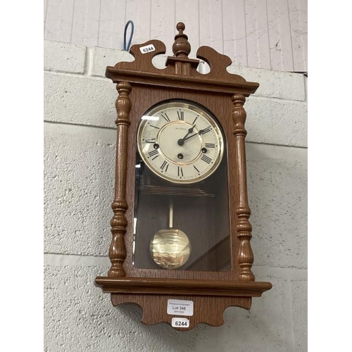 346 - Oak cased W Widdop wall clock with pendulum & key