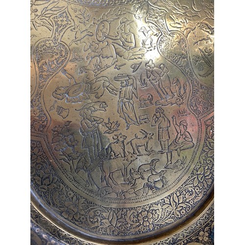 278 - 19th century Persian Qajar brass tray with fine detailing of horseman, hunters etc., 65cm diameter