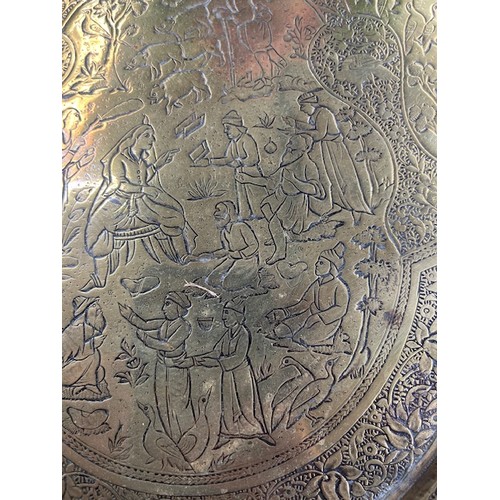 278 - 19th century Persian Qajar brass tray with fine detailing of horseman, hunters etc., 65cm diameter