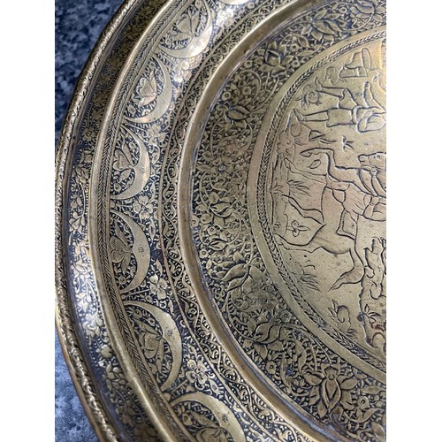 278 - 19th century Persian Qajar brass tray with fine detailing of horseman, hunters etc., 65cm diameter