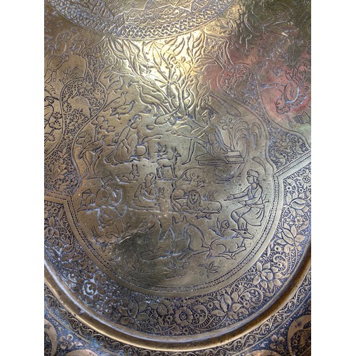 278 - 19th century Persian Qajar brass tray with fine detailing of horseman, hunters etc., 65cm diameter