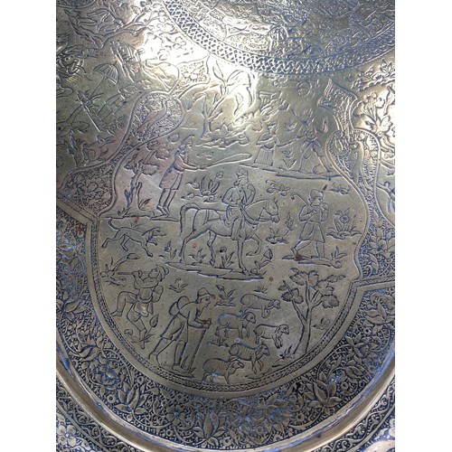 278 - 19th century Persian Qajar brass tray with fine detailing of horseman, hunters etc., 65cm diameter