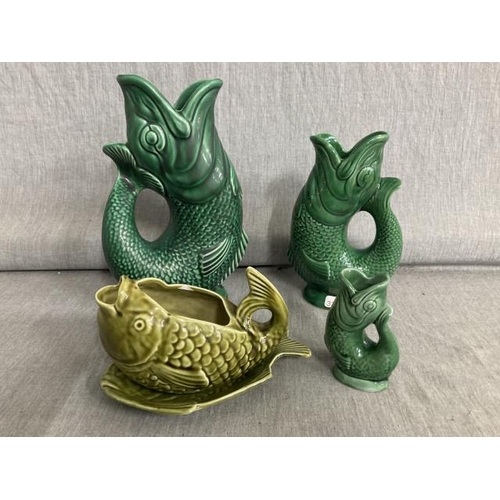 381 - 3 Dartmouth green fish gluggle jugs 23, 18 & 9H and a green Hornsea fish shaped sauce boat and stand... 