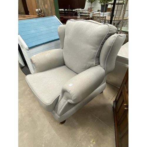 111 - Grey linen effect upholstered wing armchair 100W (marks to both arms)