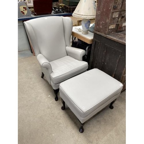 244 - Parker Knoll grey leather wing armchair 72W and a matching footstool 45H 66W 47D