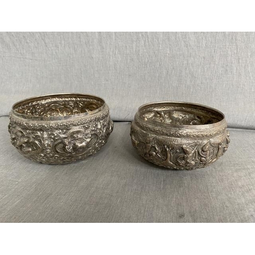 321 - Two chased & repoussé Burmese silver tone bowls, believed to be silver 379g & 455g (17cm diameter 10... 