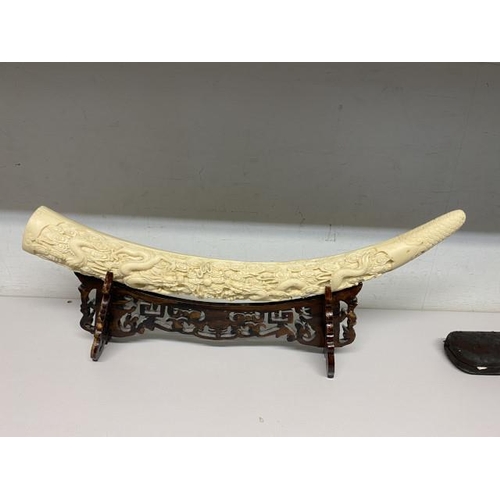 329 - Reproduction resin carved elephant tusk on stand 53W