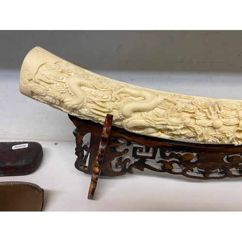 329 - Reproduction resin carved elephant tusk on stand 53W