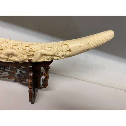 329 - Reproduction resin carved elephant tusk on stand 53W