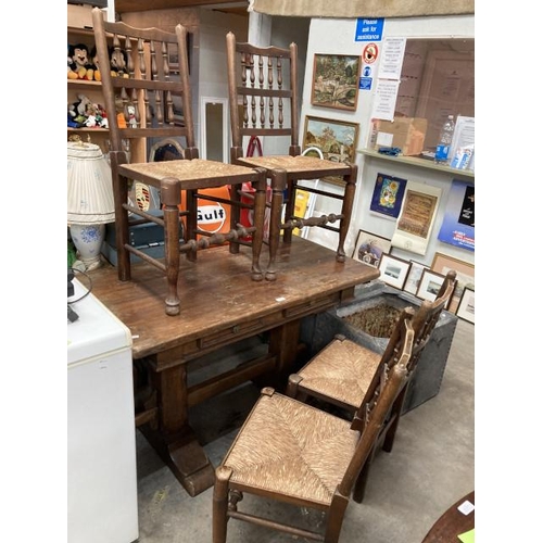 556 - Solid oak farmhouse table 78H 125W 65D with 2 drawers and 4 spindle back chairs