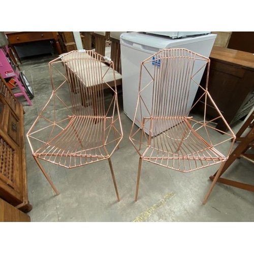 100 - Pair of contemporary wire work copper effect chairs 53W