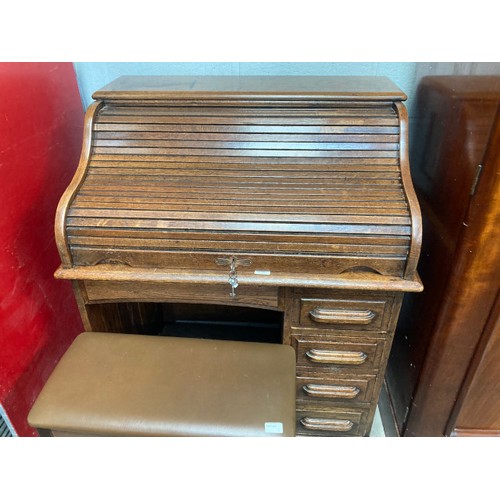 1 - 1930's oak roll top desk with tambour front and two keys 112H 91W 67D and a piano stool 64H 62W 30D