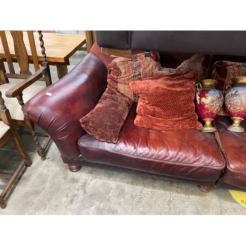 178 - Tetrad burgundy leather settee with scatter cushions 260W (splits into 2 sections) & two urns