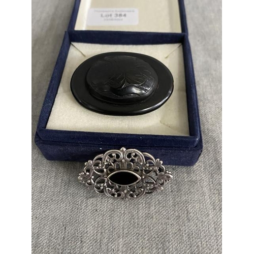 384 - Oval jet brooch & a ornate silver & jet brooch