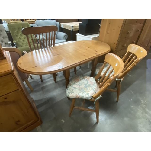 22 - Pine extending  oval kitchen table 74H 79-152W 75D and 2 pine chairs