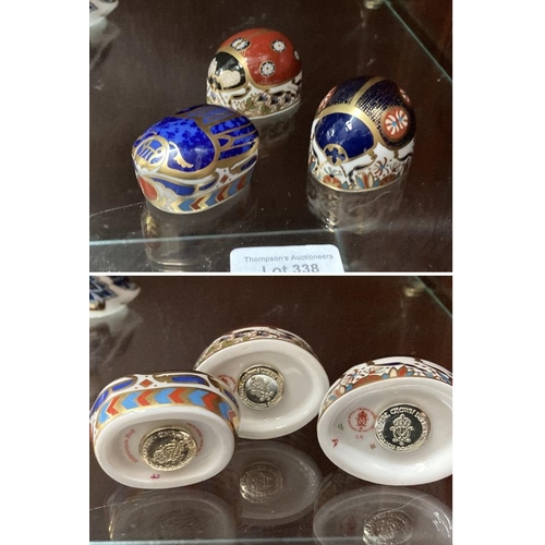 338 - Royal Crown Derby 'Millennium Bug', 'Ladybird' LX and 'Ladybird' LX paperweights all with gold stopp... 