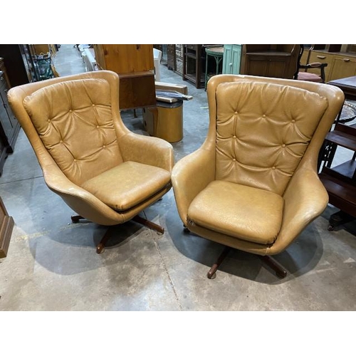 59 - A pair of mid century swivel lounge chairs upholstered in original leatherette/vinyl 94H 84W