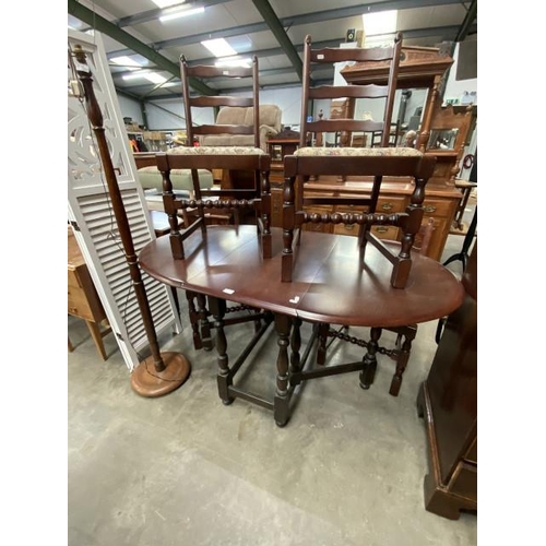 129 - Oak drop leaf table 74H 150W 89D, 4 ladder back chairs and  an oak standard lamp 150H