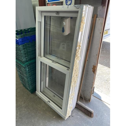 142 - 2 white UPVC sash window frames with chrome hardware 156H 79W 13D