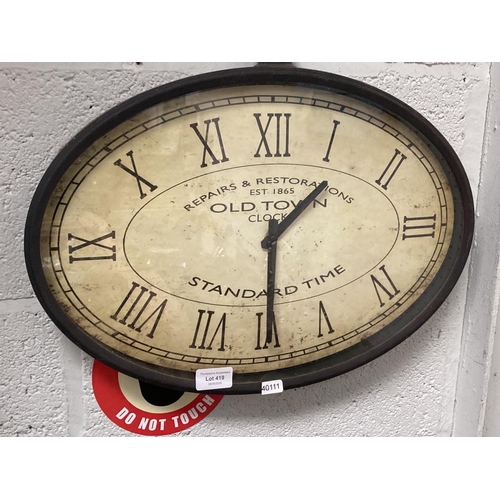 419 - Metal oval 'Repair & Restorations' wall clock 33x46cm