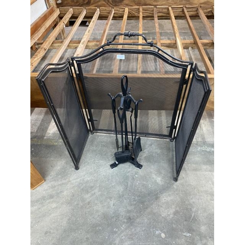 151 - Black metal folding fire screen and a companion set