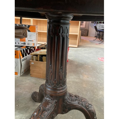 89 - George lll mahogany tilt top table with carved central column and lions head to feet 62H 80cm diamet... 