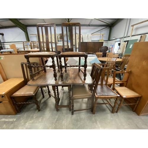 152 - Oak barley twist drop leaf table 73H 37-118W 93D with 8 assorted chairs