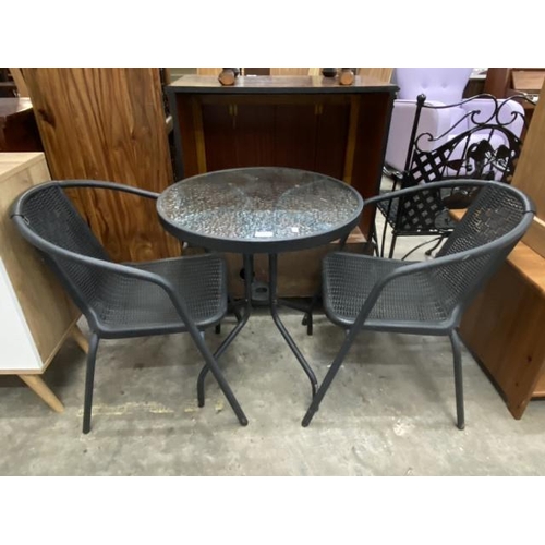 194 - Glass topped garden table 69H 60cm diameter and 2 chairs