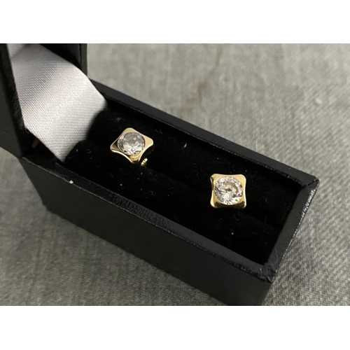 318 - Pair of 9ct gold square framed solitaire stud earrings