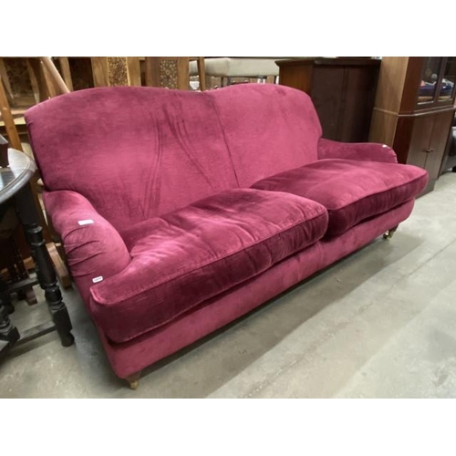 68 - Burgundy velvet settee with brass castors 188W