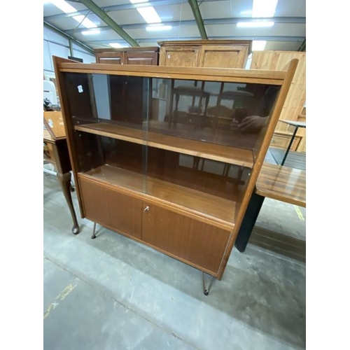 75 - Mid century teak glazed bookcase with 2 doors, sitting on hairpin legs 118H 100W 26D