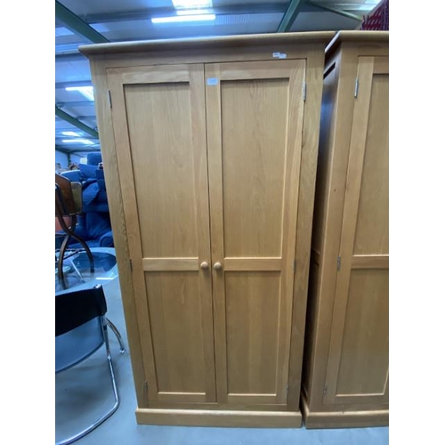 56 - Good quality oak two door wardrobe with hanging rail and shelf to the interior 188H 96W 57D