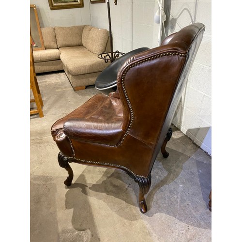 133 - Artsome - A Coach House, Brown leather wing back armchair 110H 79W 70D