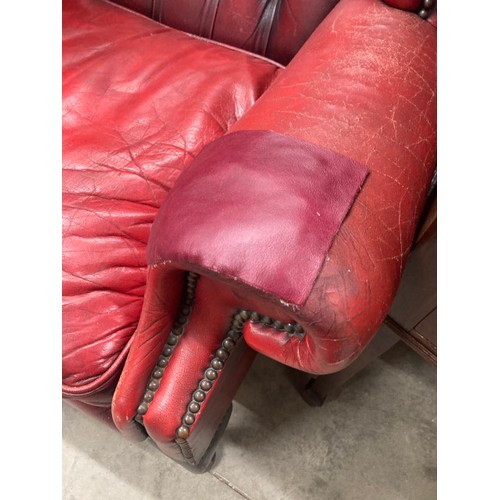 57 - Pair of ox blood leather button back Chesterfield wing armchairs 110H 87W 90D (both sold as seen)