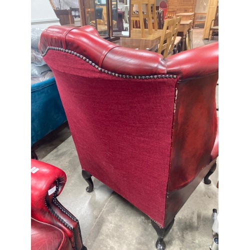 57 - Pair of ox blood leather button back Chesterfield wing armchairs 110H 87W 90D (both sold as seen)